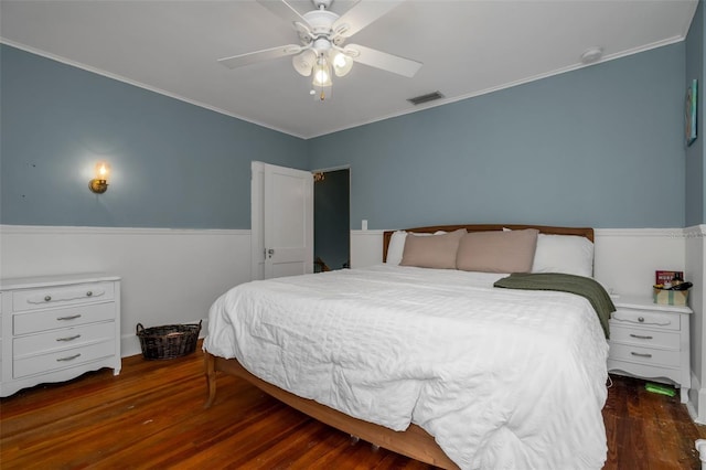 bedroom with ceiling fan, dark wood-type flooring, and crown molding