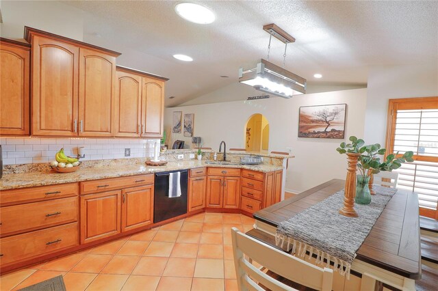 kitchen with decorative light fixtures, light tile patterned flooring, tasteful backsplash, dishwasher, and a textured ceiling