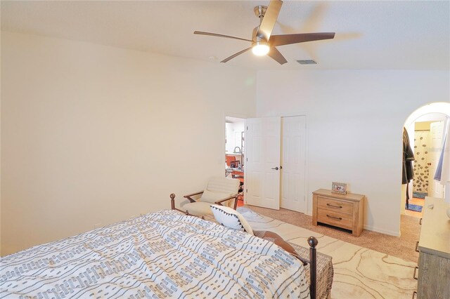 carpeted bedroom featuring ceiling fan and high vaulted ceiling