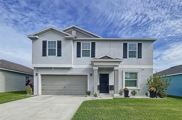 front of property featuring a garage and a front lawn