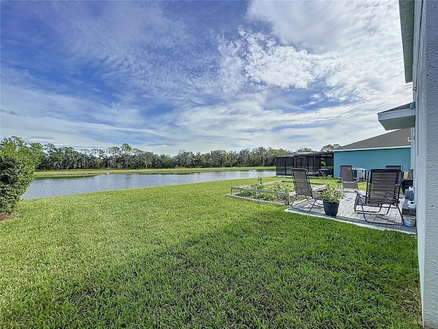 view of yard with a water view and a patio area