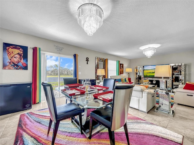 tiled dining area with a textured ceiling and a chandelier