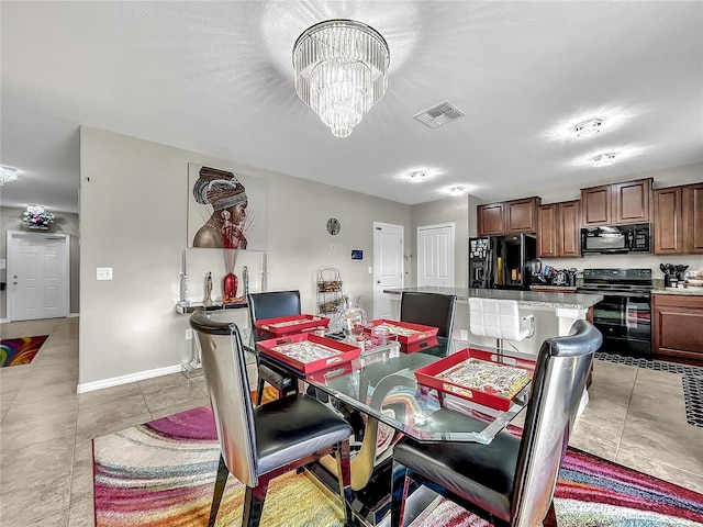 dining space featuring light tile patterned floors and a notable chandelier