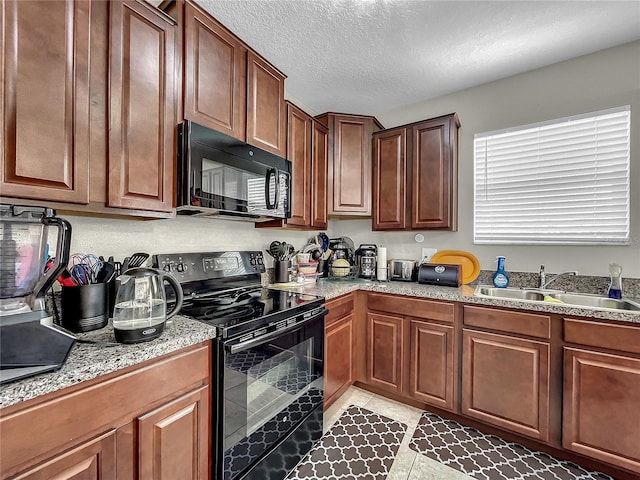 kitchen with black appliances, sink, and a textured ceiling