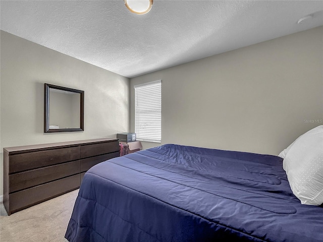 carpeted bedroom with a textured ceiling