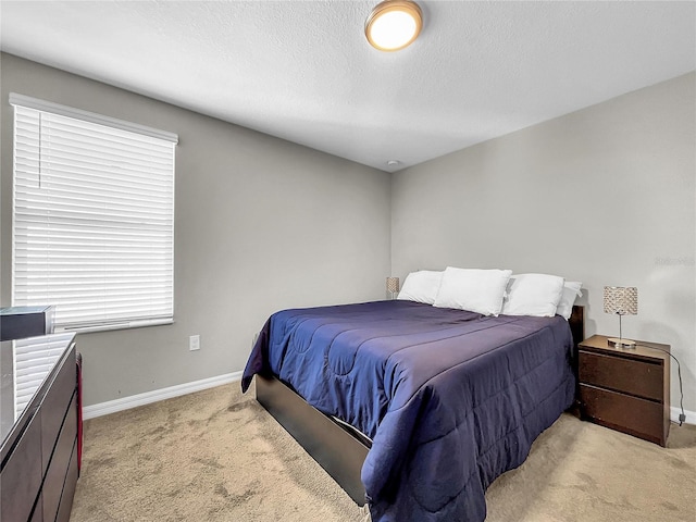 carpeted bedroom featuring a textured ceiling