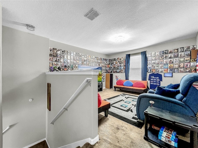 carpeted living room featuring a textured ceiling