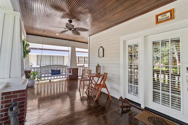 sunroom / solarium featuring wooden ceiling and ceiling fan