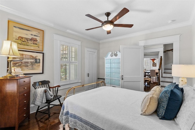 bedroom featuring ornamental molding, dark hardwood / wood-style flooring, and ceiling fan