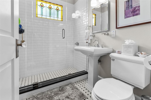 bathroom featuring tile patterned floors, toilet, and an enclosed shower