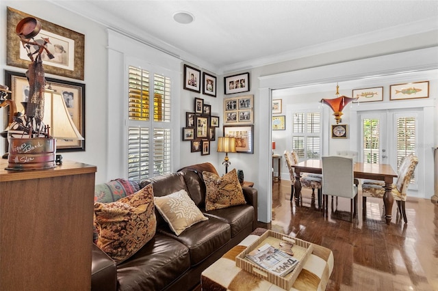 living room with crown molding, dark hardwood / wood-style flooring, and french doors