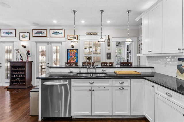 kitchen with white cabinetry, sink, decorative light fixtures, and dishwasher