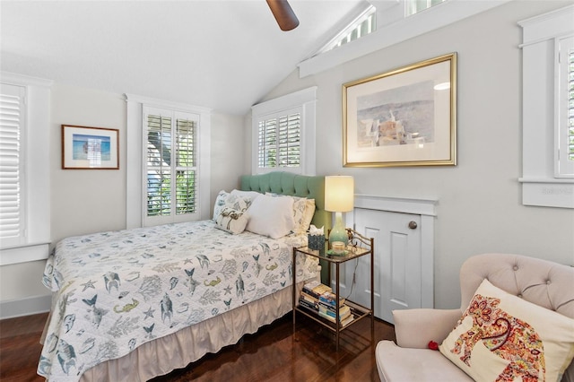 bedroom featuring ceiling fan, dark hardwood / wood-style floors, and vaulted ceiling