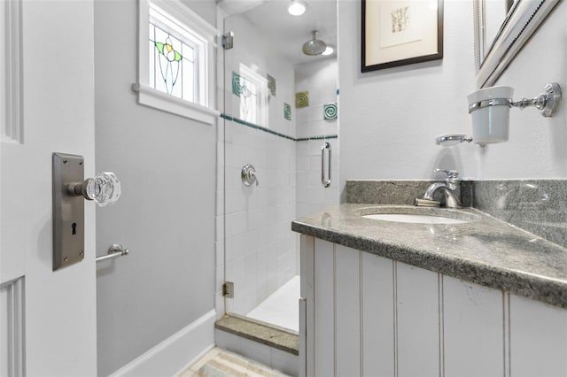 bathroom featuring sink and a shower with shower door