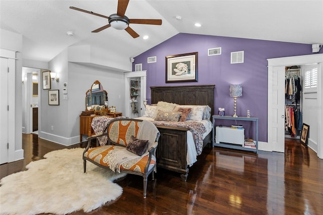 bedroom with dark hardwood / wood-style flooring, lofted ceiling, ceiling fan, and a closet