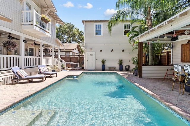 view of pool featuring ceiling fan and a patio area