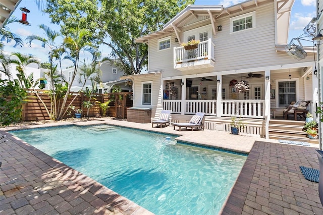 view of swimming pool featuring a patio and ceiling fan