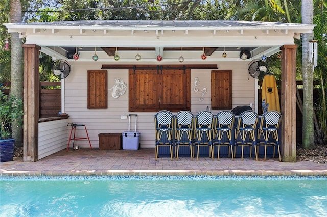 view of pool with a bar and a patio area