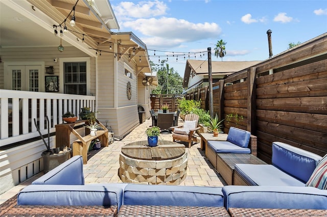 view of patio / terrace with an outdoor living space with a fire pit