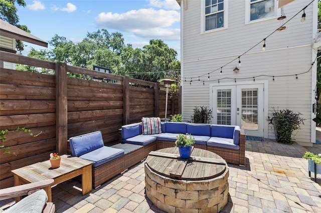 view of patio featuring french doors and an outdoor living space with a fire pit