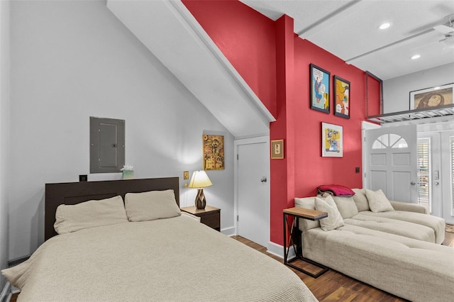 bedroom featuring lofted ceiling, electric panel, and hardwood / wood-style floors