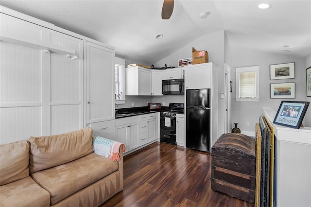 kitchen with sink, black appliances, white cabinets, dark hardwood / wood-style flooring, and vaulted ceiling