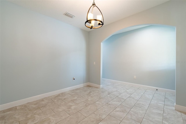 unfurnished room featuring light tile patterned floors and a notable chandelier