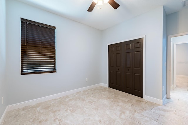 unfurnished bedroom featuring a closet, ceiling fan, and light tile patterned floors