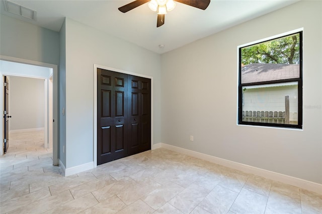 unfurnished bedroom with a closet and ceiling fan