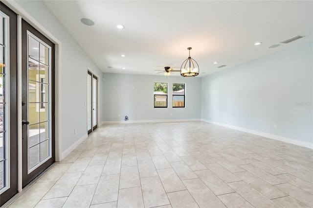 unfurnished room featuring a chandelier and light tile patterned floors