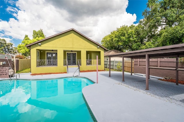 view of pool with a carport and ceiling fan