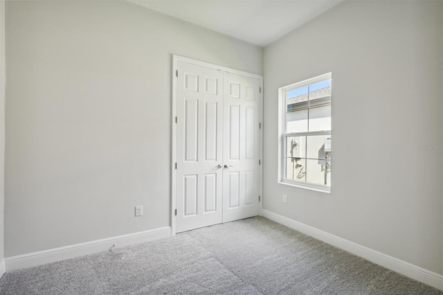 unfurnished bedroom featuring a closet and carpet floors