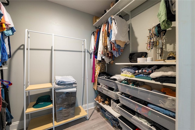 walk in closet with light wood-type flooring