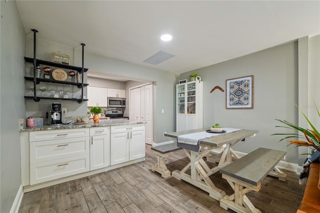 dining space with light hardwood / wood-style floors