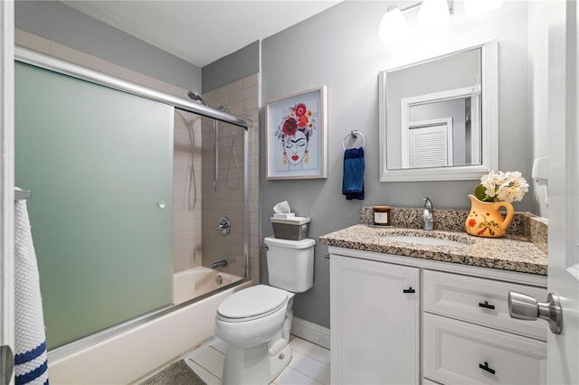 full bathroom featuring vanity, combined bath / shower with glass door, tile patterned floors, and toilet