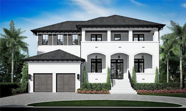 view of front of property featuring a garage, roof with shingles, decorative driveway, french doors, and stucco siding