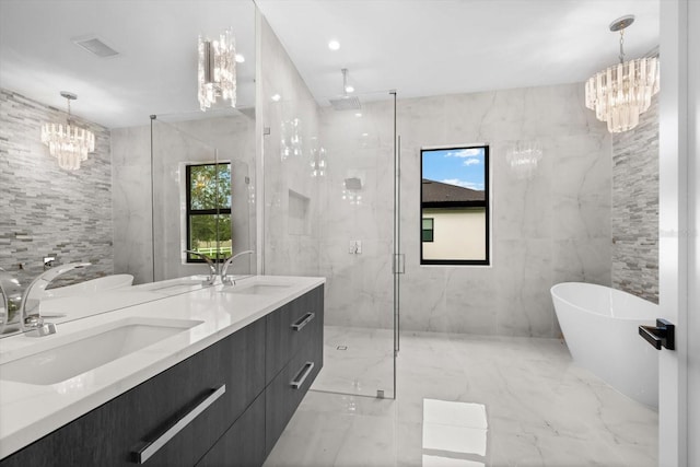 bathroom with tile walls, plus walk in shower, and an inviting chandelier