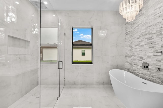 bathroom featuring a chandelier and independent shower and bath