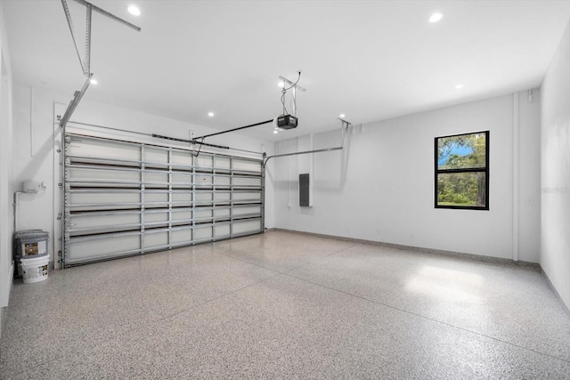 garage with electric panel and a garage door opener