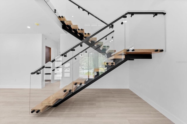 stairway with hardwood / wood-style flooring