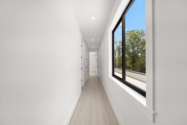 corridor with light hardwood / wood-style floors