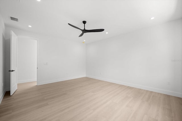 empty room featuring ceiling fan and light hardwood / wood-style floors