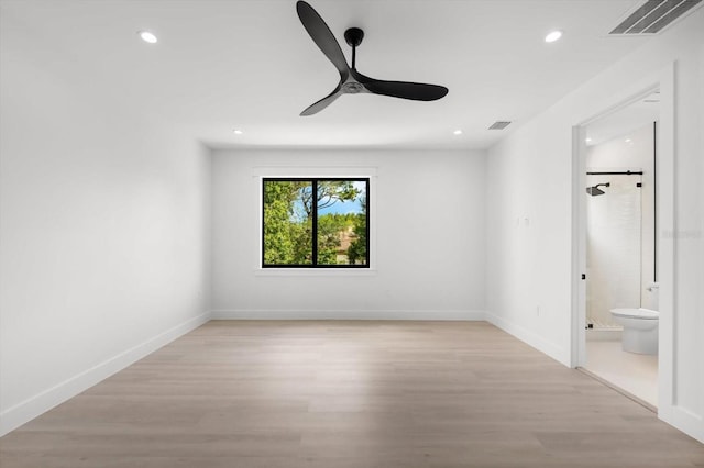 unfurnished bedroom featuring ceiling fan, light wood-type flooring, and ensuite bathroom