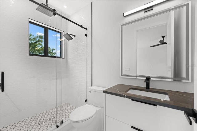 bathroom with toilet, vanity, and an enclosed shower