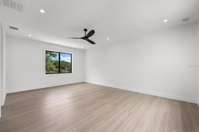 spare room with ceiling fan and light wood-type flooring