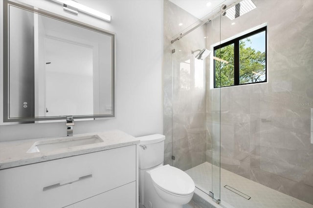 bathroom featuring vanity, toilet, and a shower with door