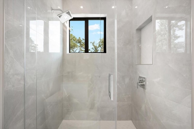 bathroom with a shower with door