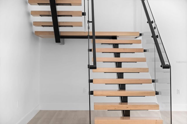 stairs featuring hardwood / wood-style flooring