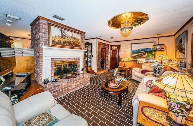 living room featuring crown molding, a brick fireplace, and a textured ceiling