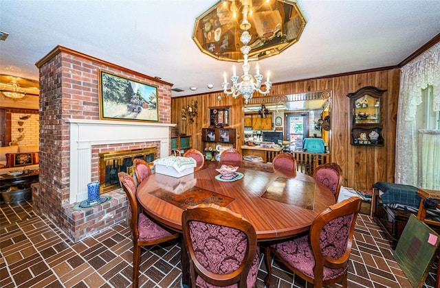 dining room featuring a fireplace, ornamental molding, and wooden walls